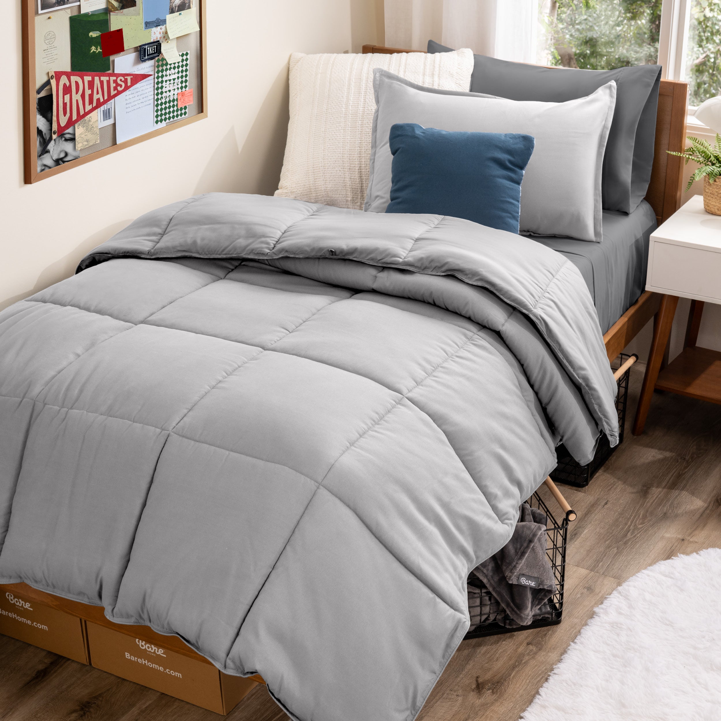 A college dorm room with a bed in a bag set on the mattress