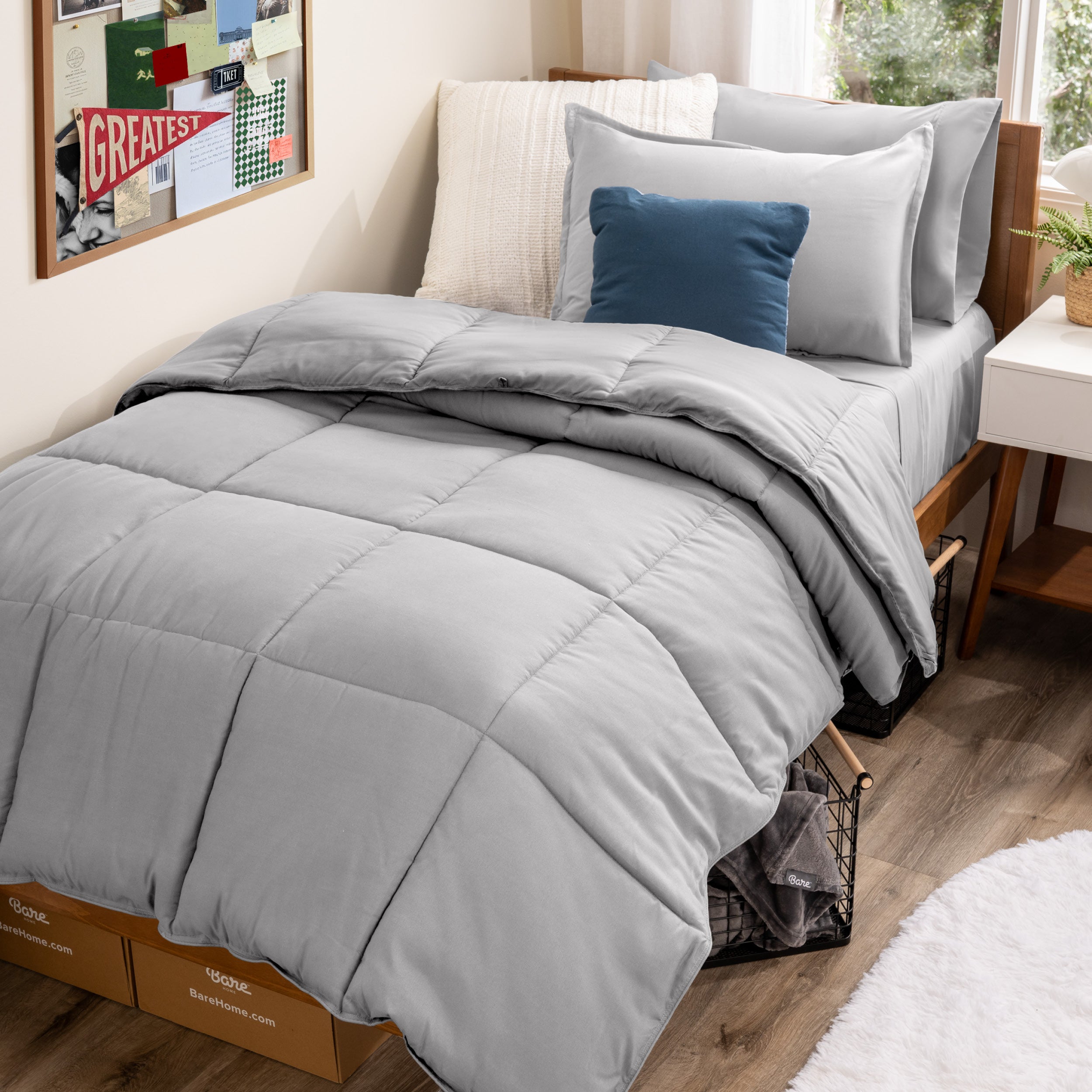 A college dorm room with a bed in a bag set on the mattress