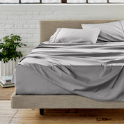 Microfiber sheet set on a bed with a white brick wall in the background