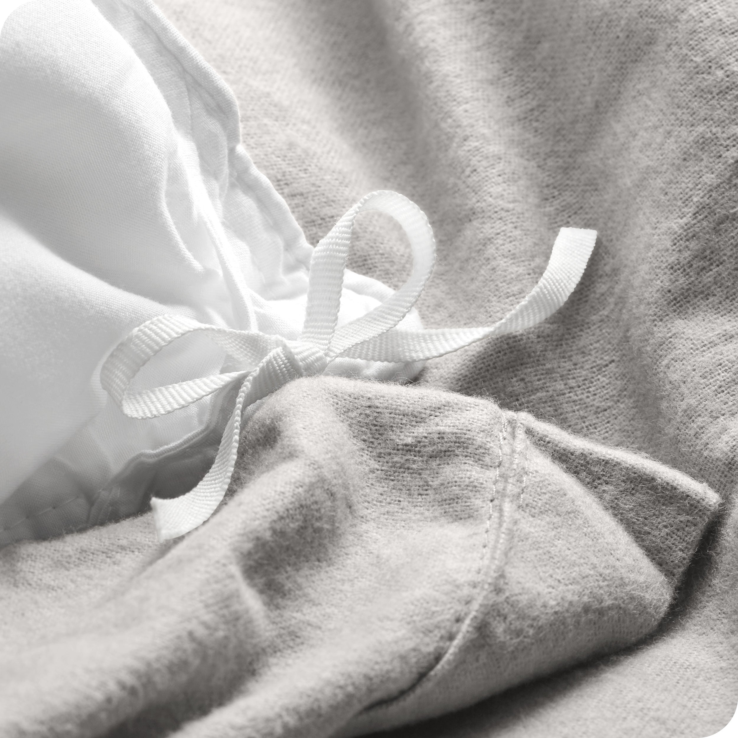 A folded stack of a flannel duvet cover with two pillows on top.