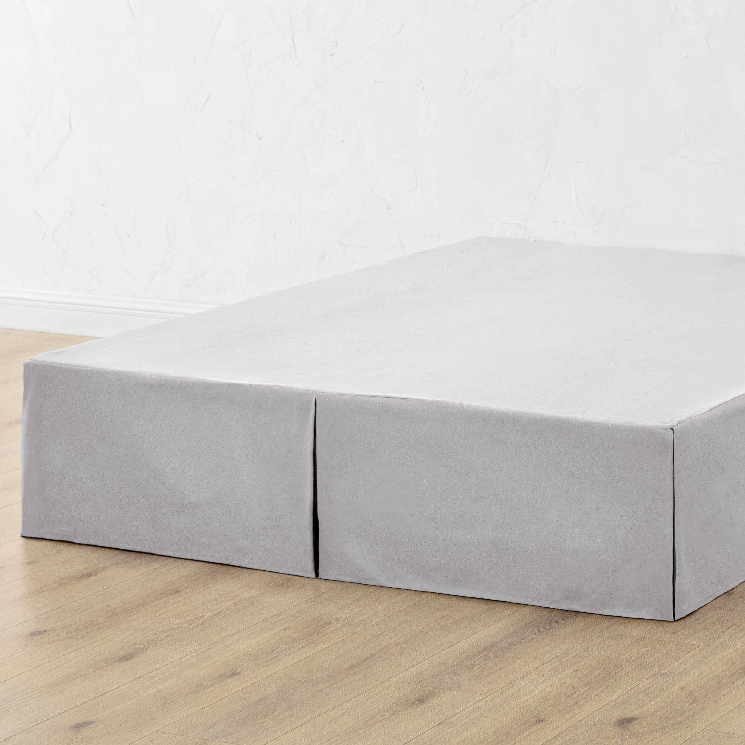 A bed skirt draped over a box spring