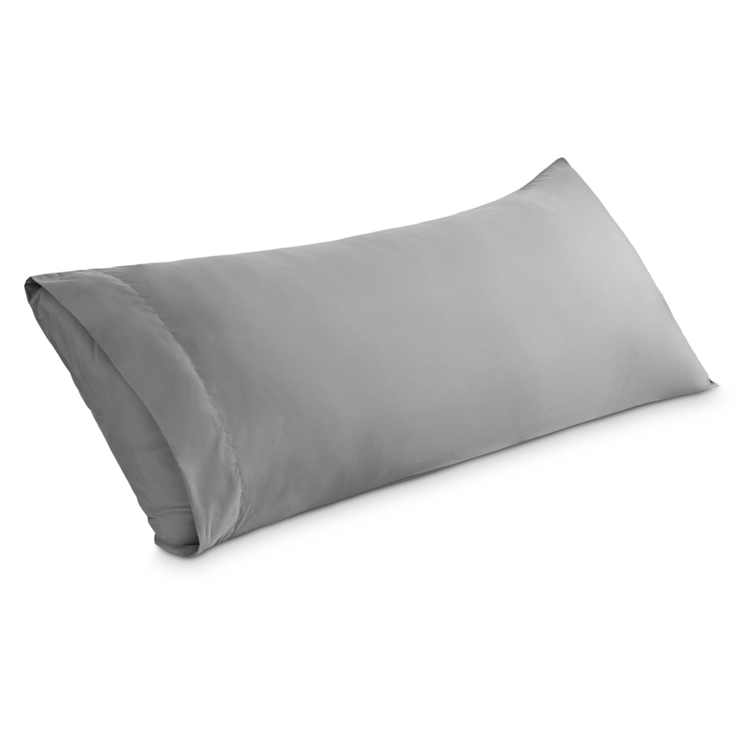 A body pillowcase on a pillow set against a headboard