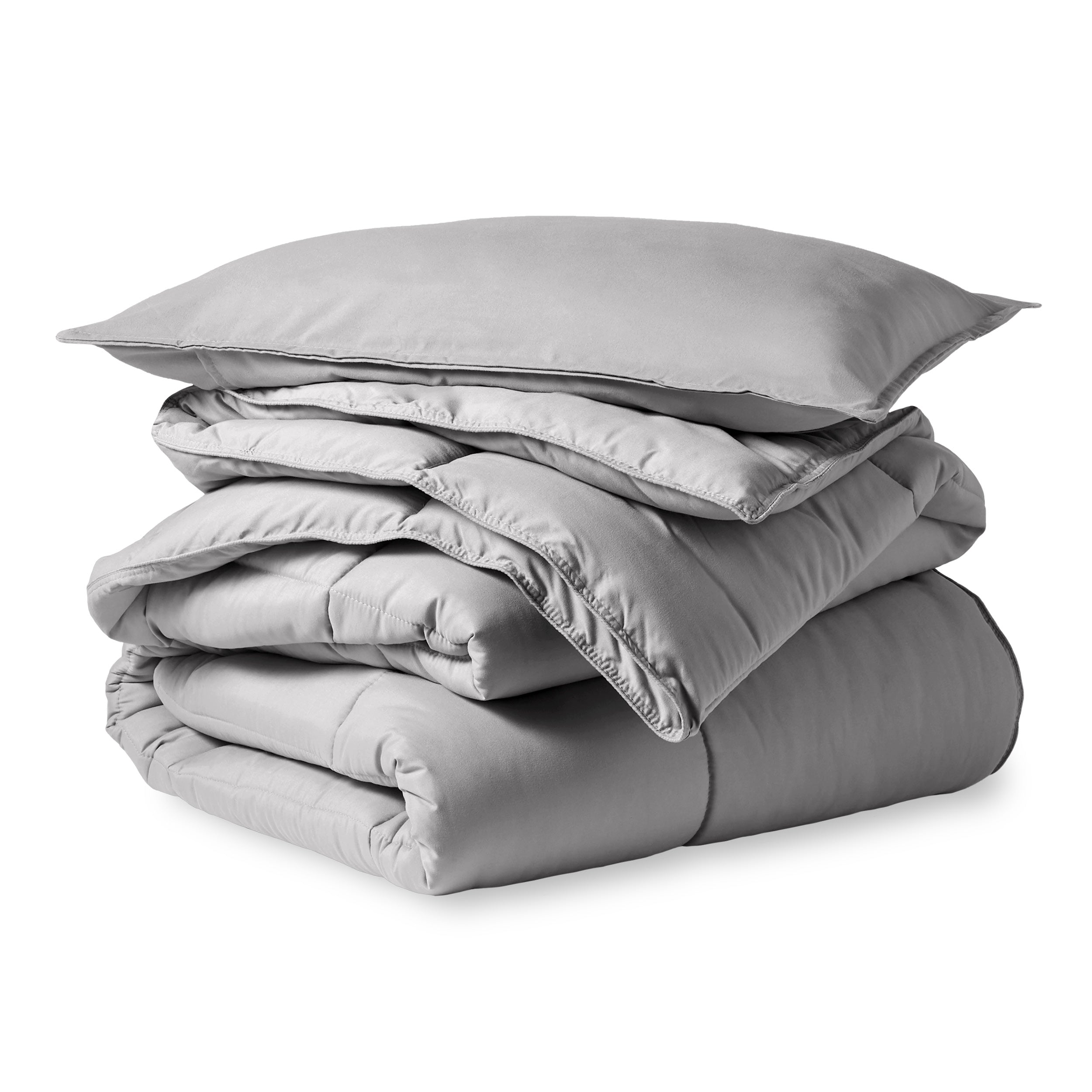 A microfiber comforter folded neatly with a pillow from above