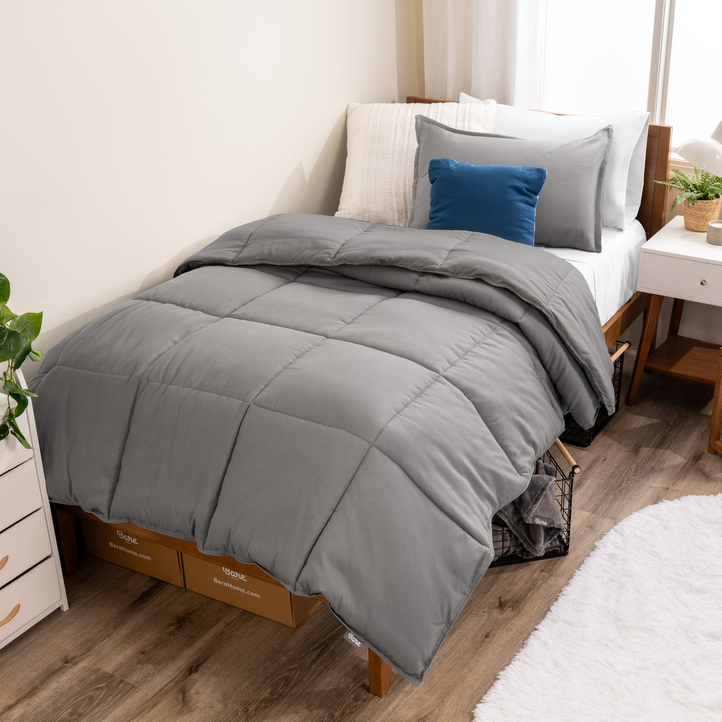 A modern bed with a down alternative comforter set on it