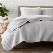 A quilted coverlet set on a bed