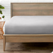 End of bed view with fitted sheet made on the mattress of a modern bed. 