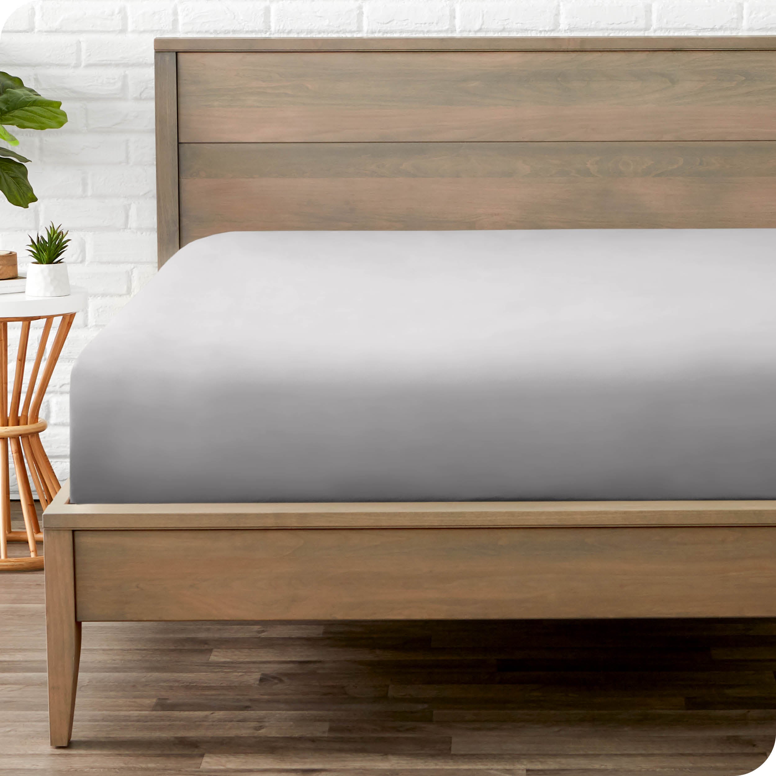 End of bed view with fitted sheet made on the mattress of a modern bed. 