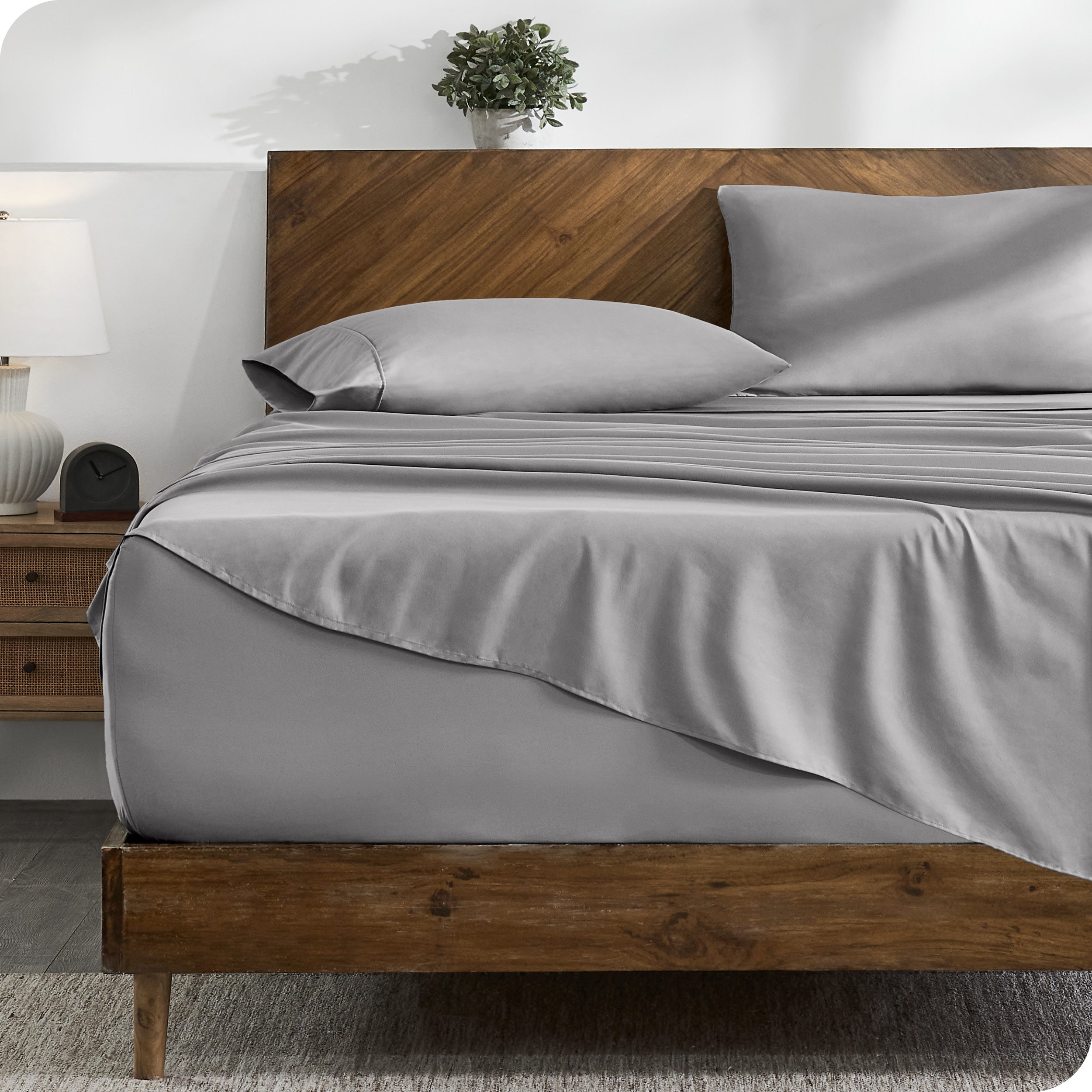 A cozy bedroom with a bed covered in soft microfiber sheets

