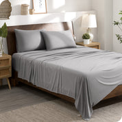 A stretch knit microfiber sheet set on a bed