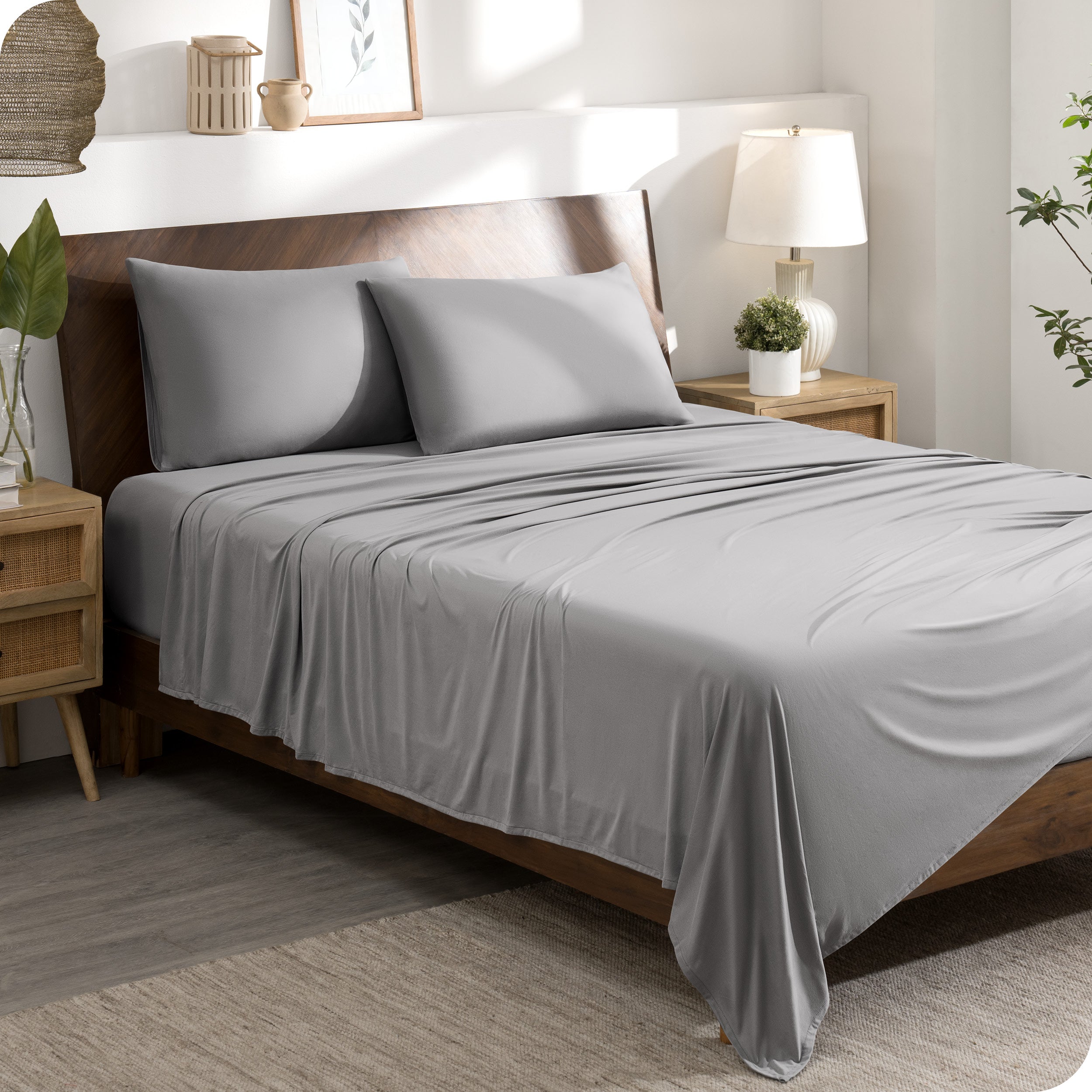 A stretch knit microfiber sheet set on a bed