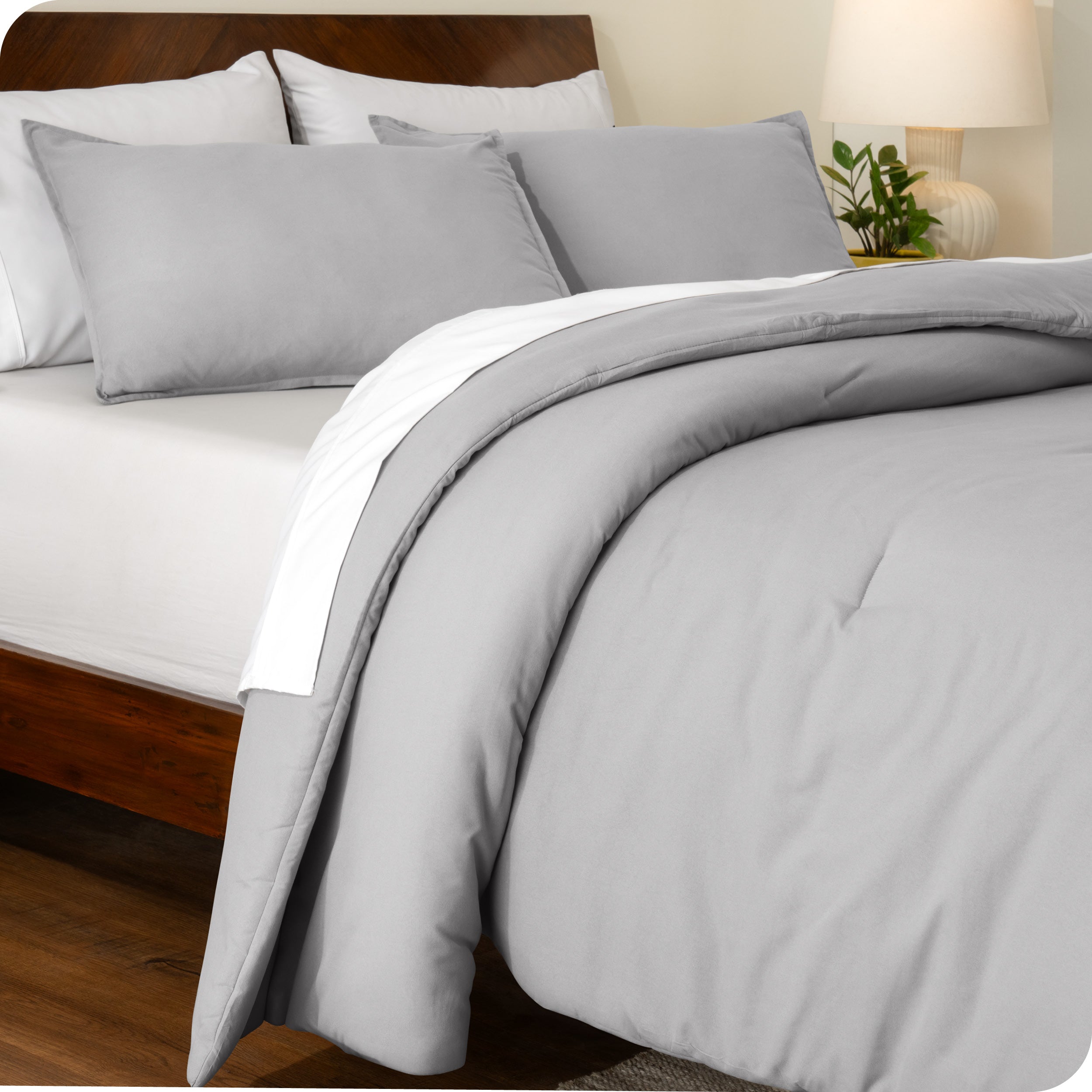 A side view of a bed made with a track stitch comforter set