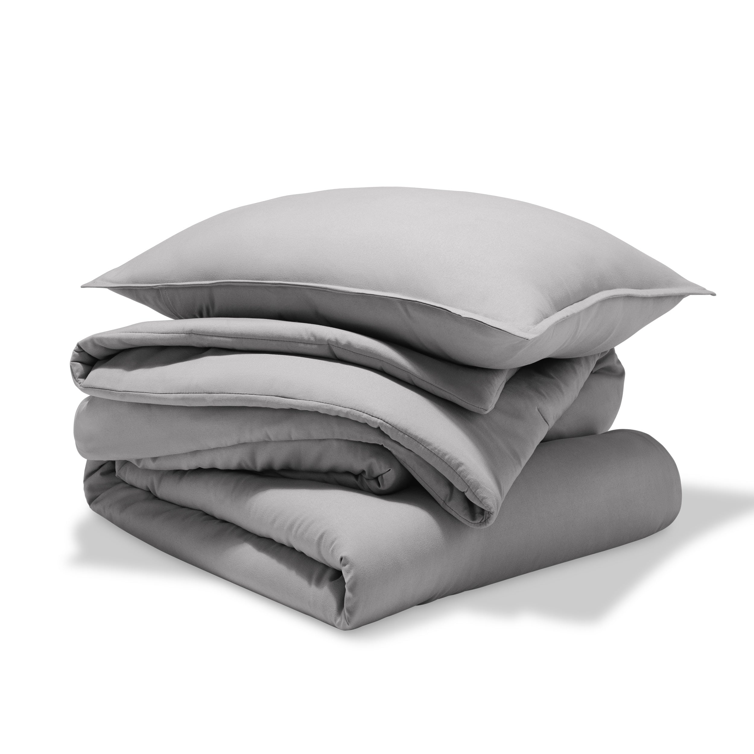 A comforter folded with a matching pillow sham stacked on top