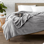 Microplush blanket laid out over a bed and folded back over itself