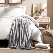 Microplush blanket laid out over a bed and folded back over itself