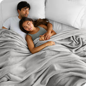 A couple sleeping while covered with a microplush blanket