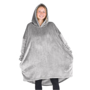 A woman standing with a wearable blanket on