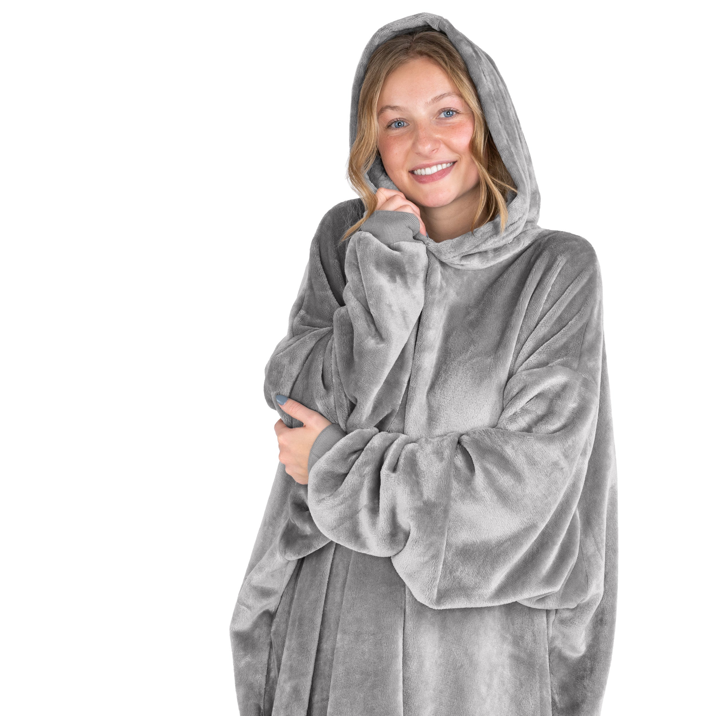 A smiling woman has a hooded wearable blanket on