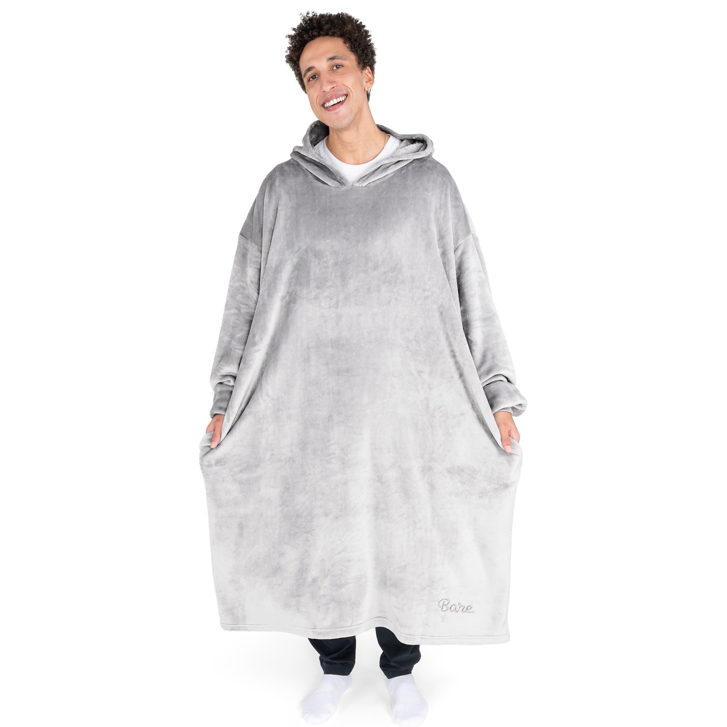 An adult with long microplush wearable blanket on
