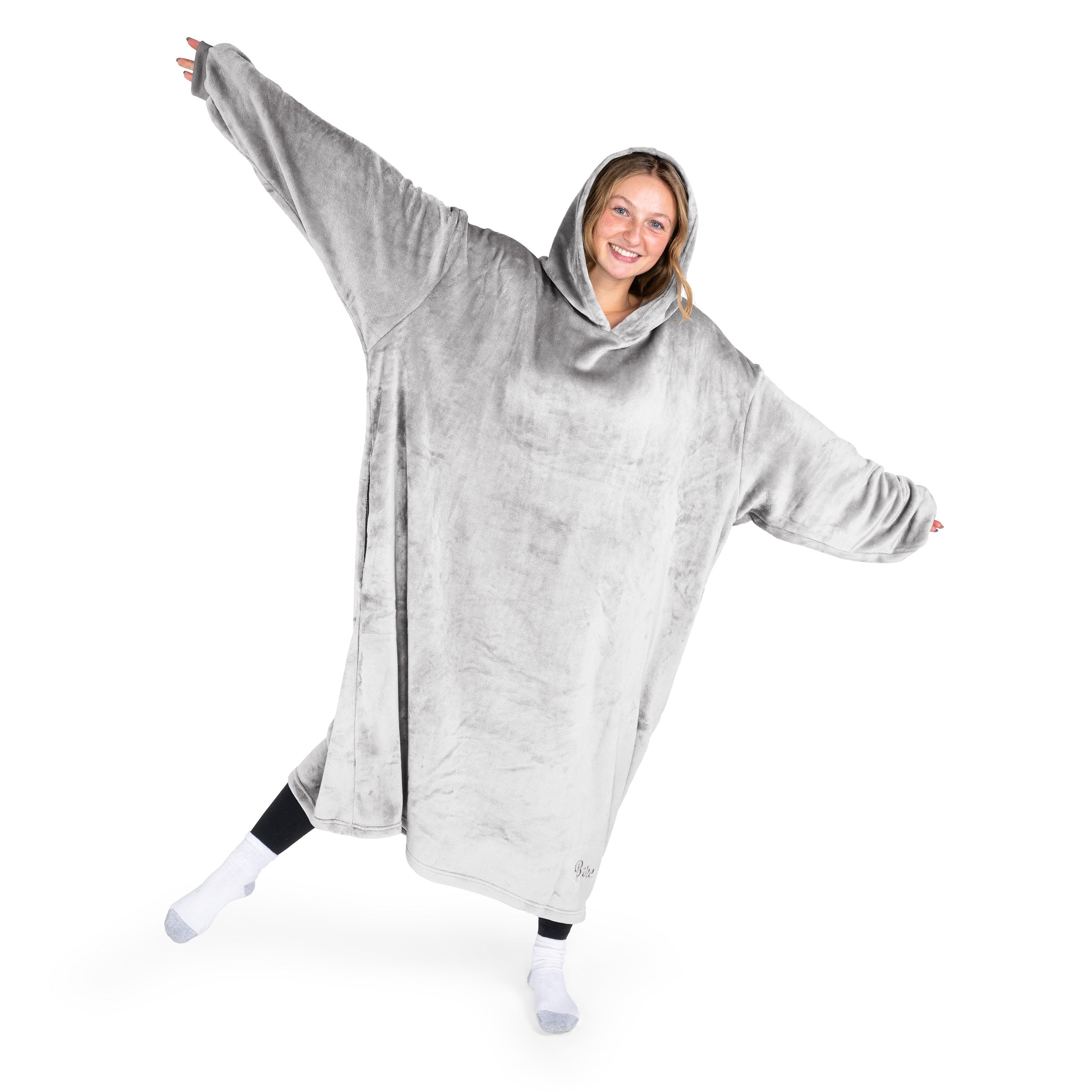 A woman has a hooded wearable blanket on