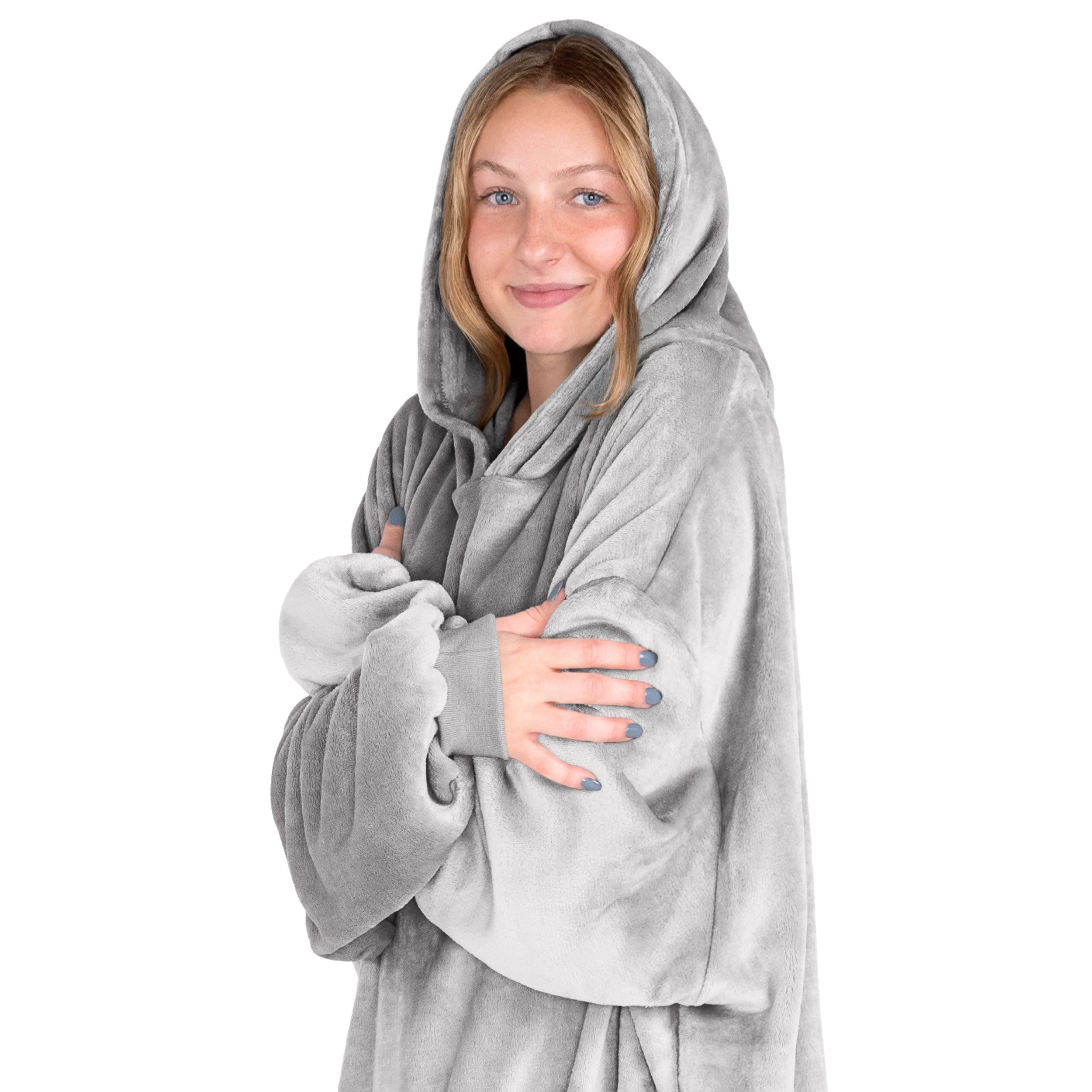 A woman is snuggled up in microplush wearable blanket