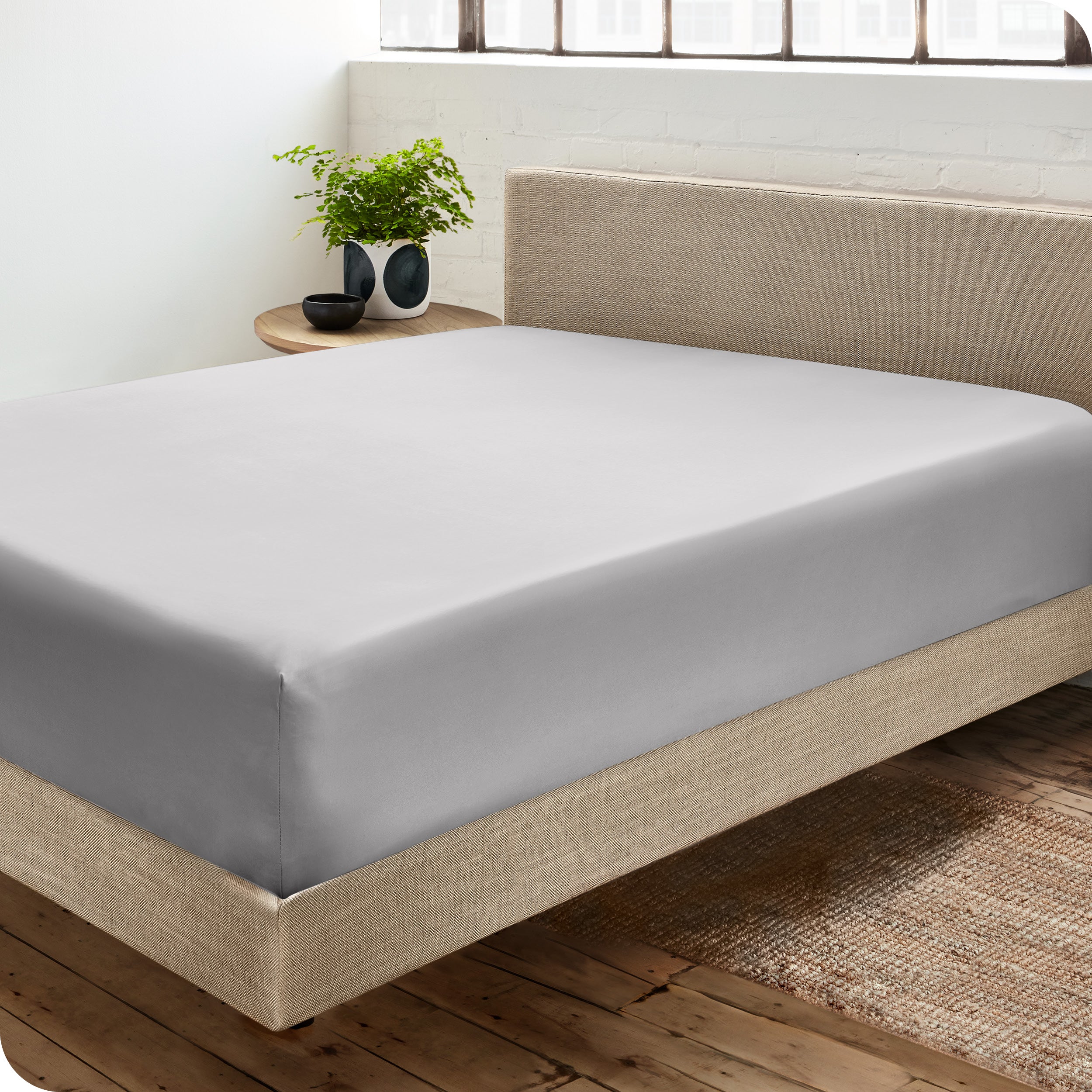 A sateen fitted sheet on a bed