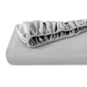 A single fitted sheet folded neatly showing part of the elastic