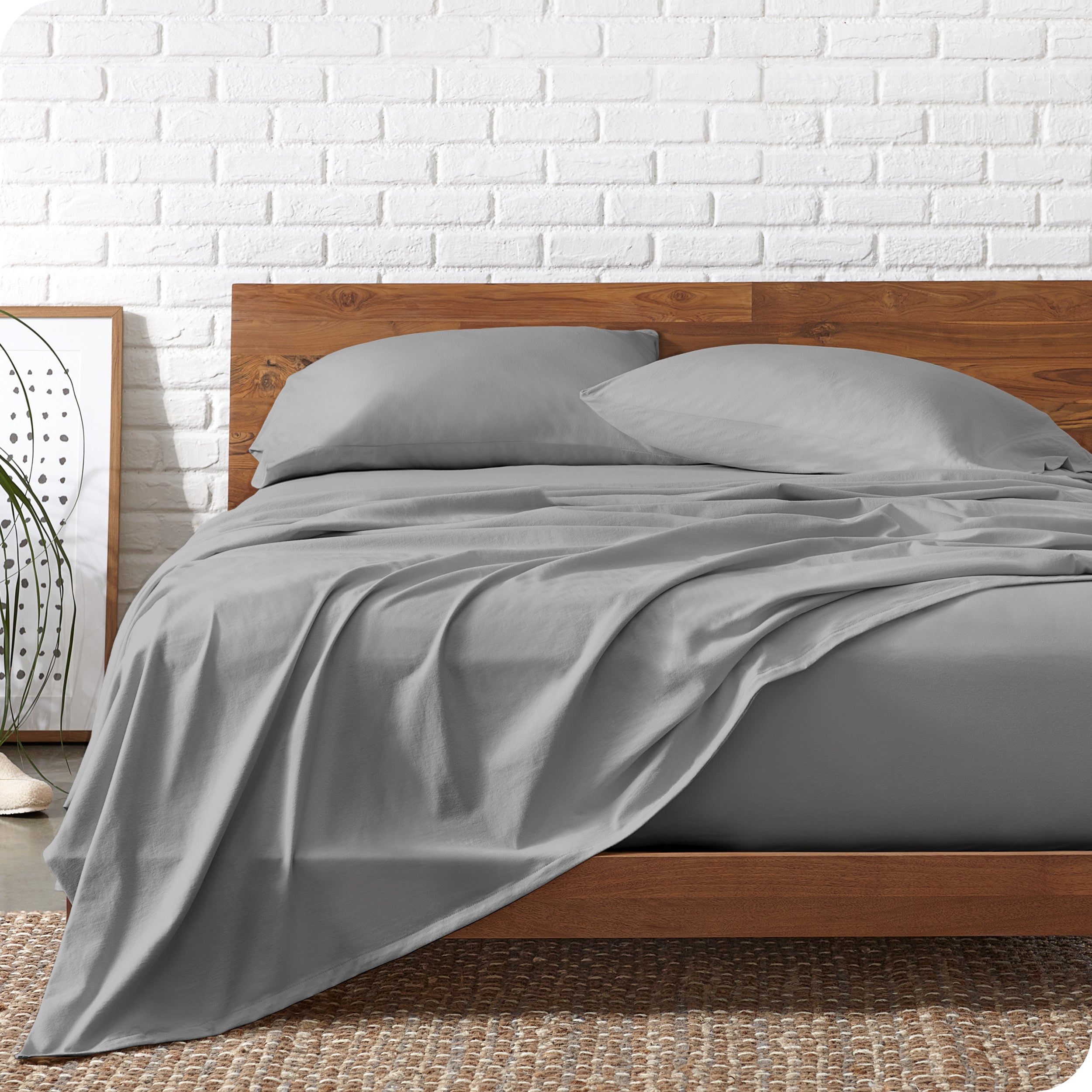 Organic jersey sheets on a bed with a wooden bed frame