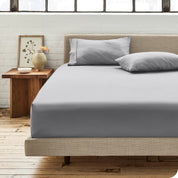 Percale fitted sheet on a mattress with matching pillowcases on pillows