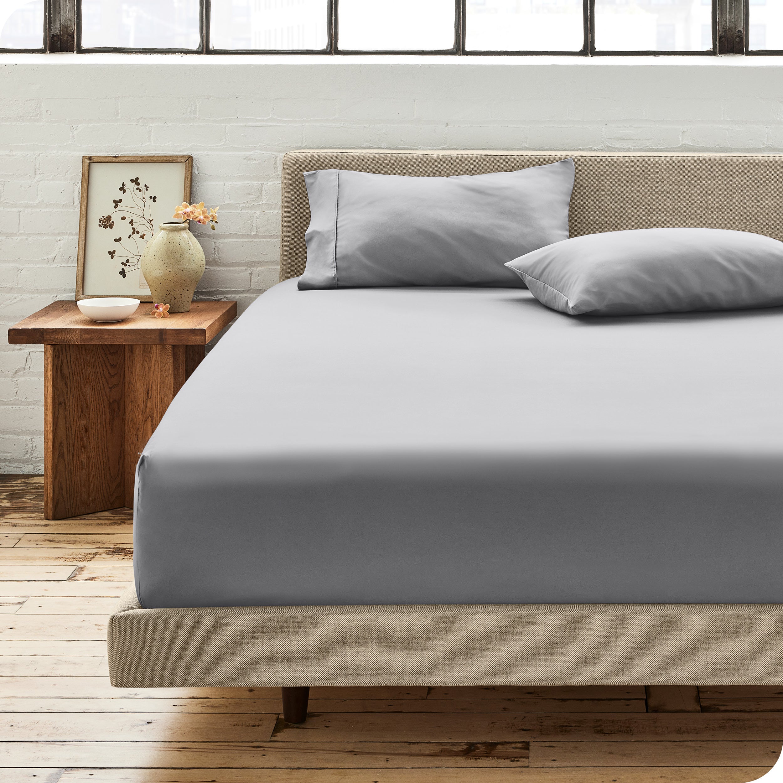 Percale fitted sheet on a mattress with matching pillowcases on pillows