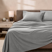 View of fleece sheets from the end of a bed with the top sheet draped over the side and end