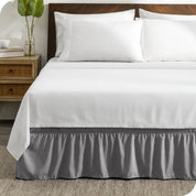 A wrap around bed skirt on a bed