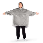 An adult with a sherpa wearable blanket on