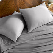 TENCEL™ pillowcases on pillows near a wooden headboard