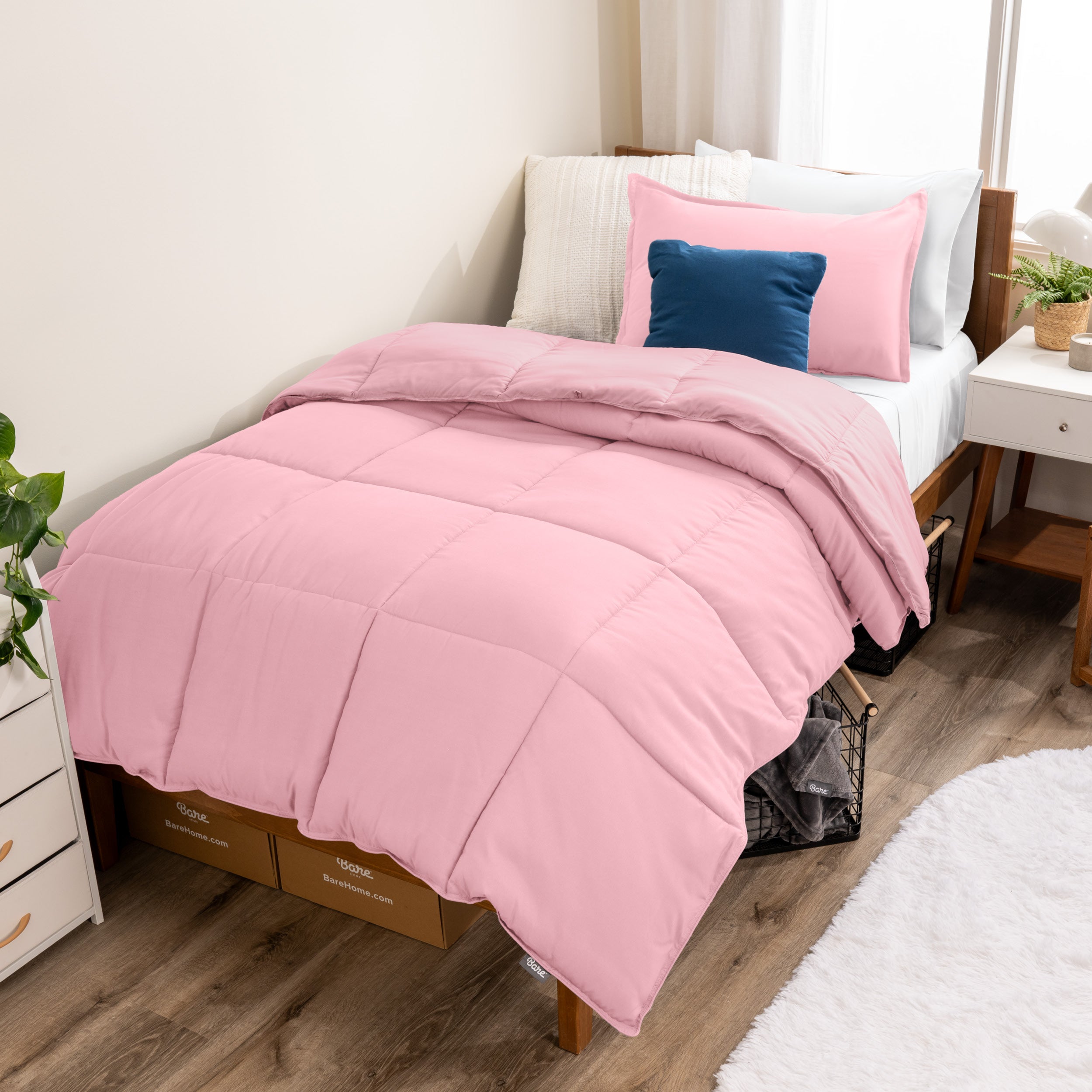 A modern bed with a down alternative comforter set on it