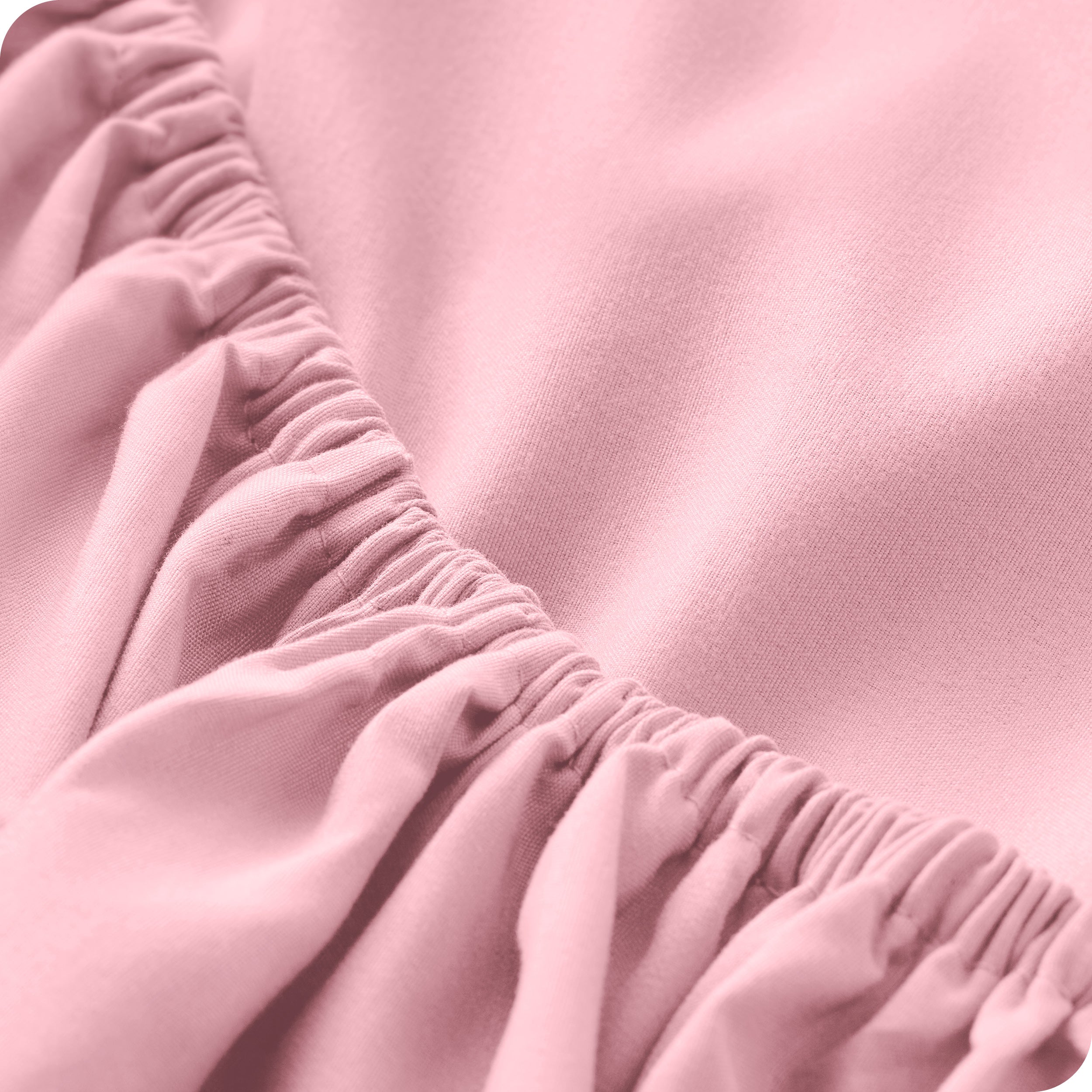 A modern bed with a fitted microfiber sheet on it