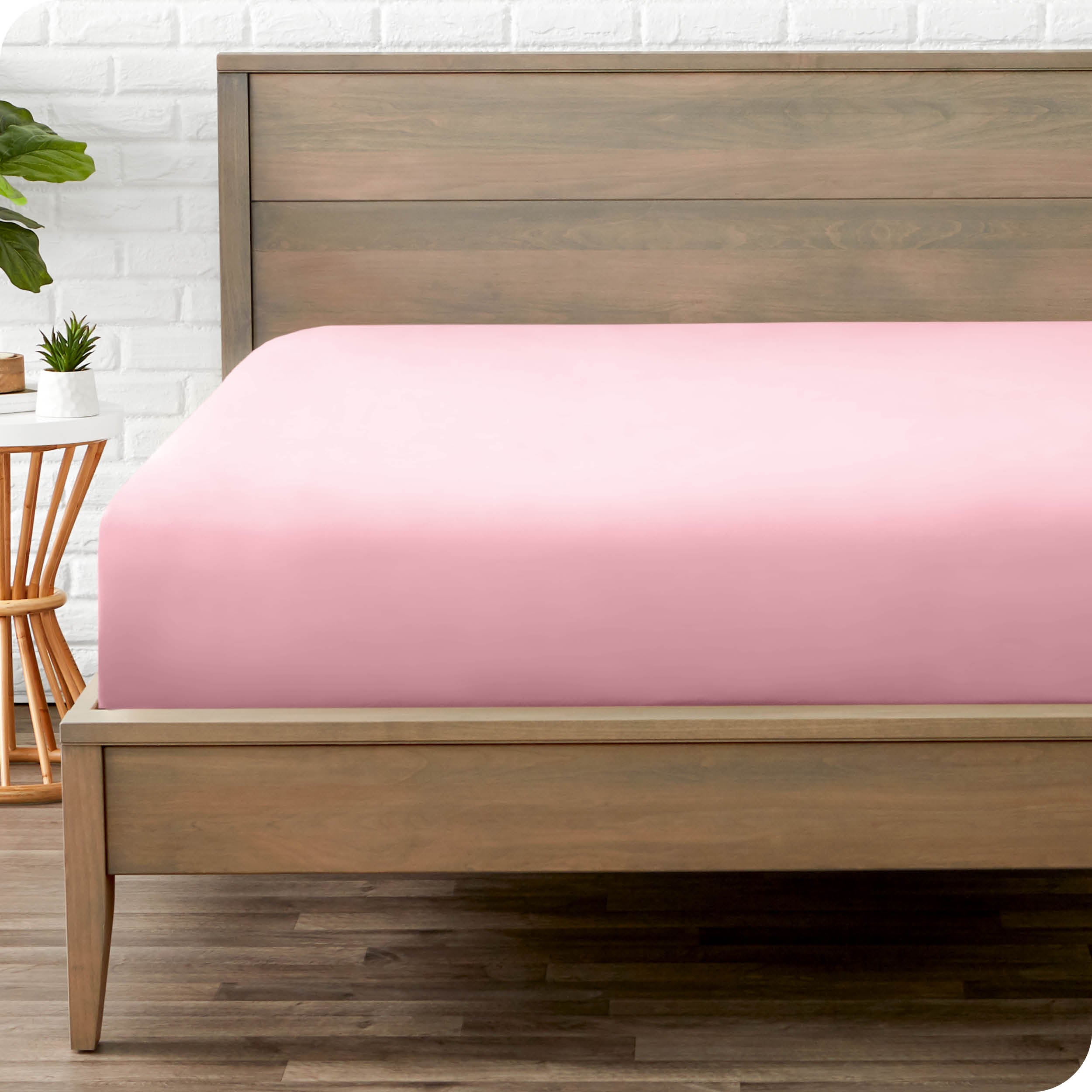 End of bed view with fitted sheet made on the mattress of a modern bed. 