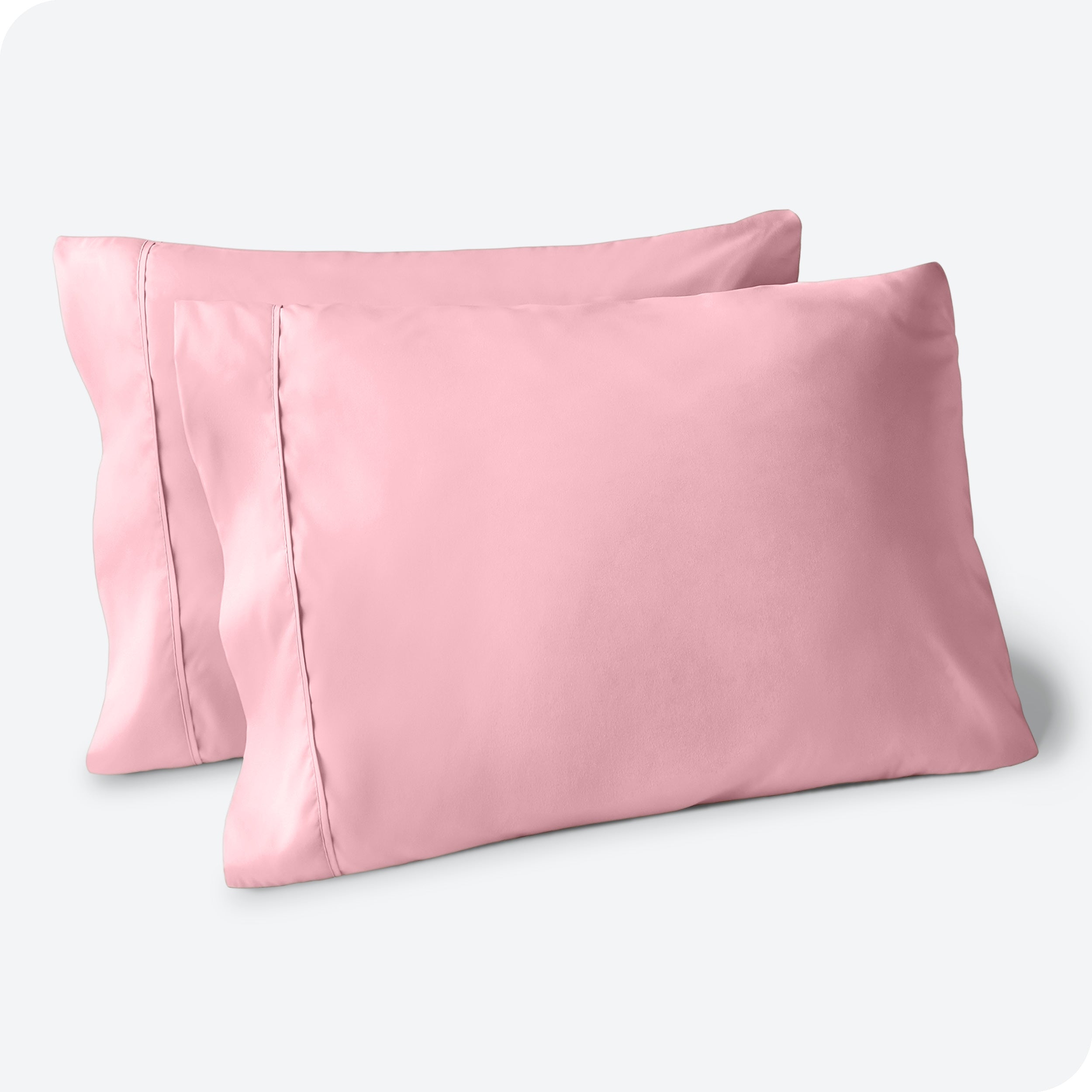 Two pillows on a white background with blue pillowcases on them
