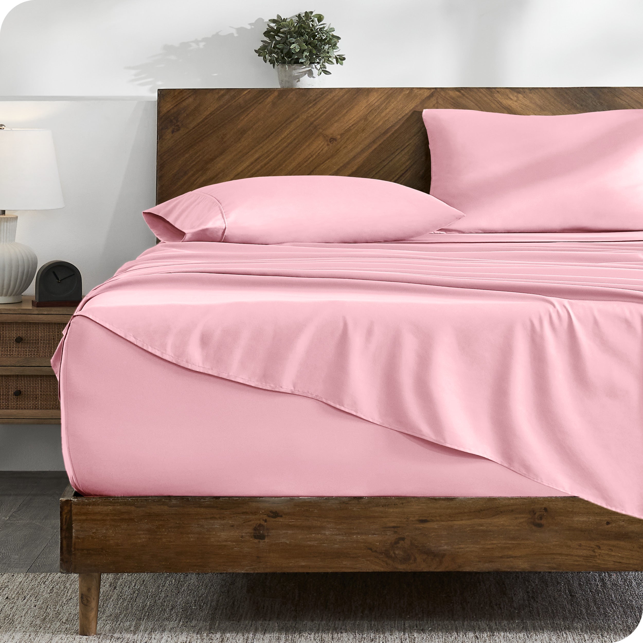 A cozy bedroom with a bed covered in soft microfiber sheets

