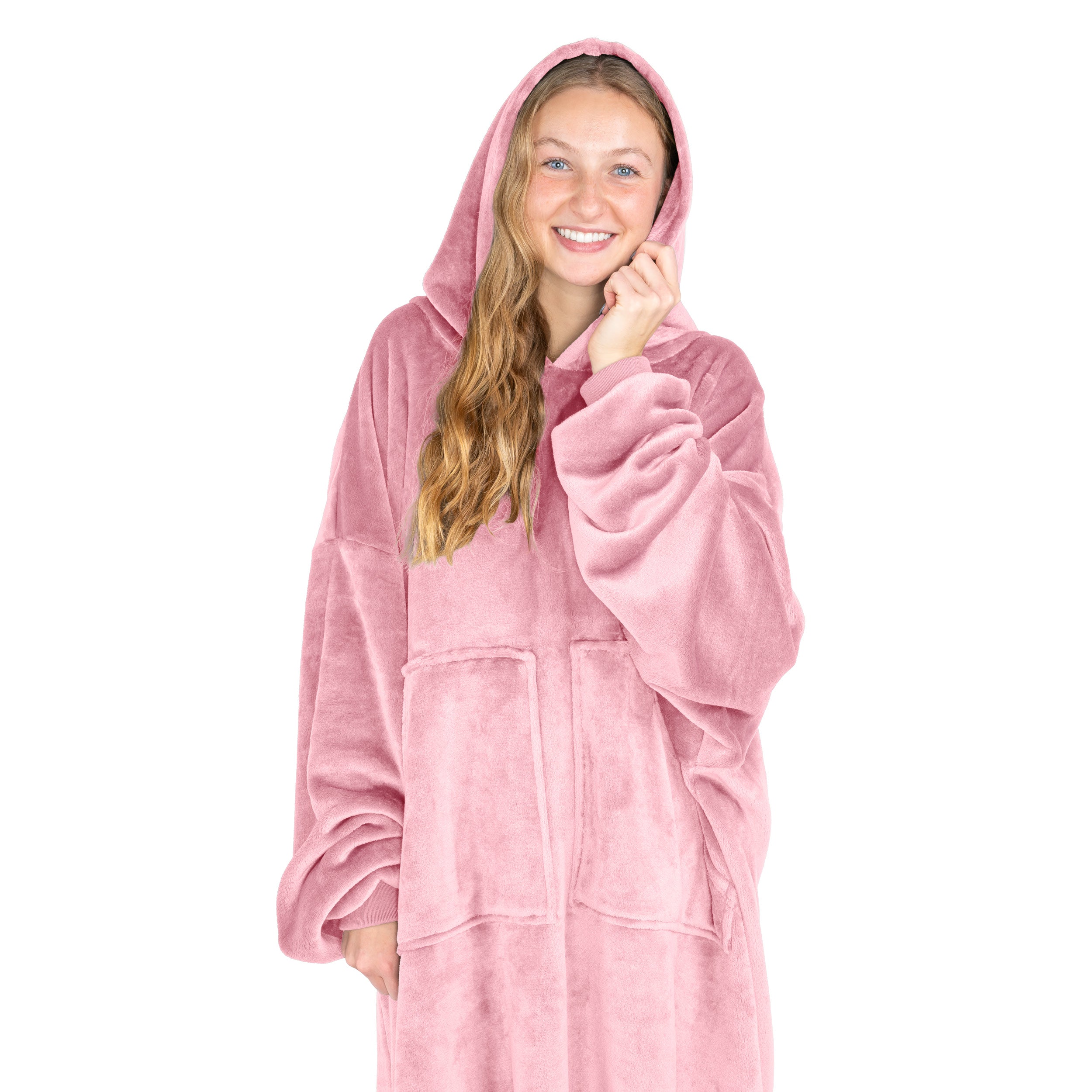 An adult is standing while wearing a microplush wearable blanket