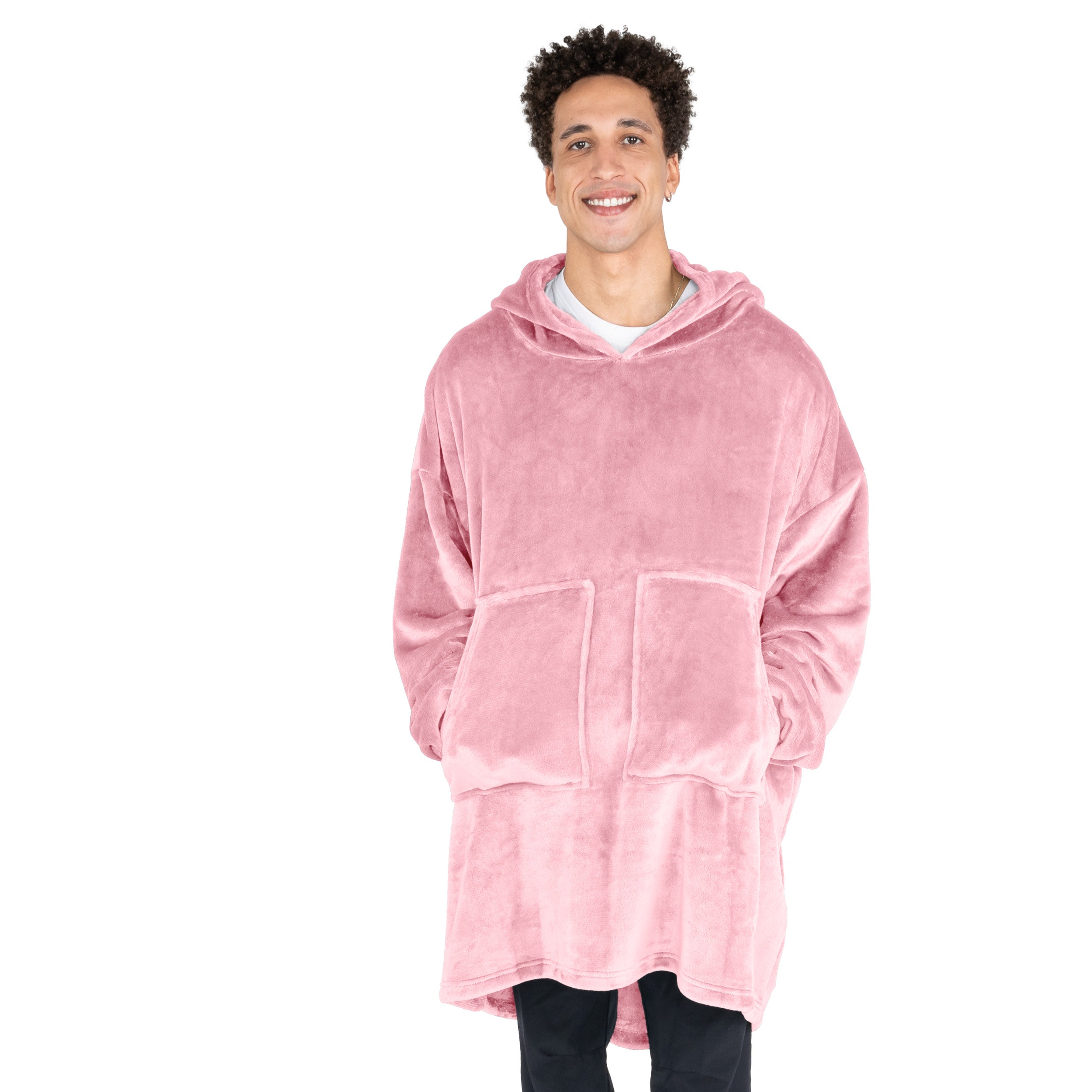 A man with his hands in the pockets of the wearable blanket he has on