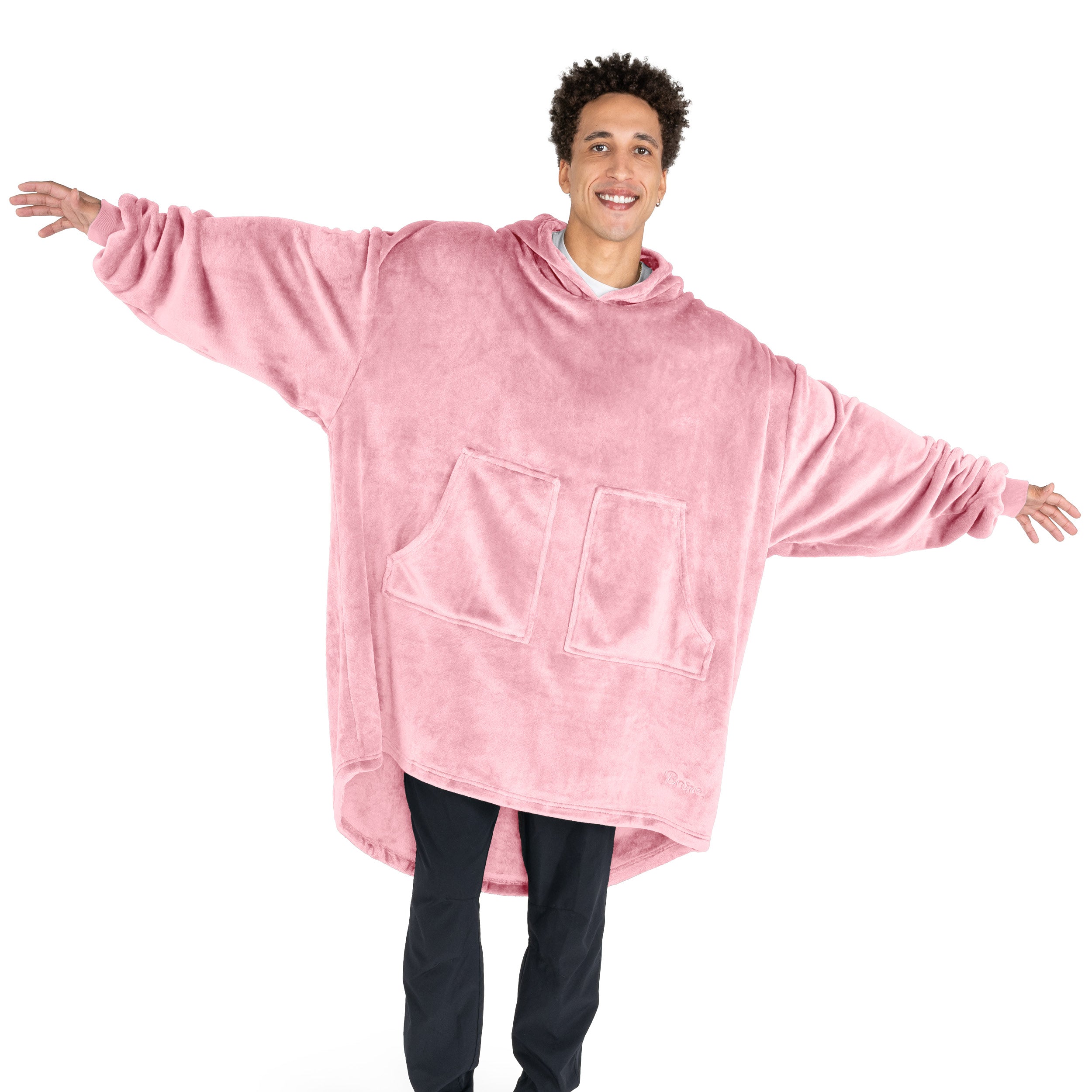 An adult with microplush wearable blanket on
