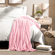 Microplush blanket laid out over a bed and folded back over itself