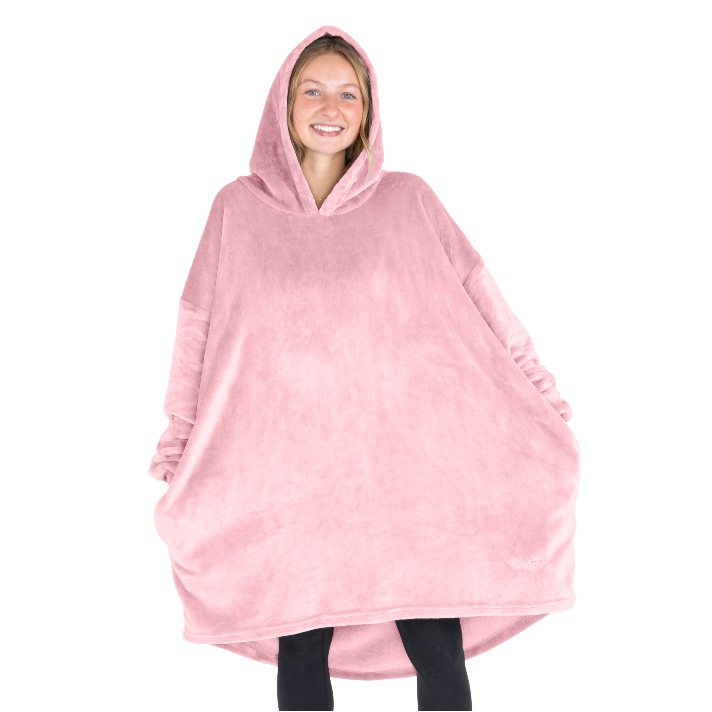 A woman standing with a wearable blanket on