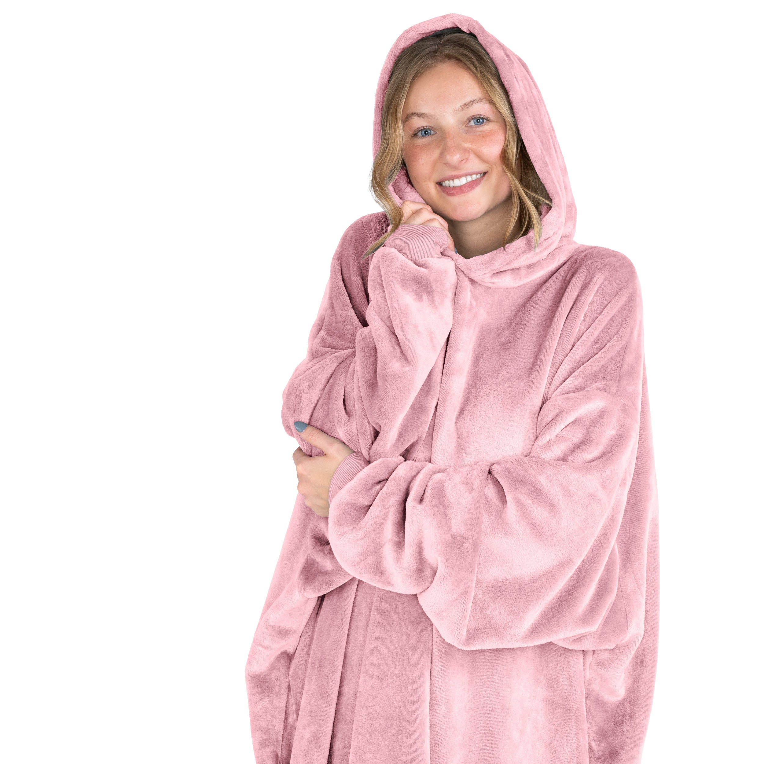 A smiling woman has a hooded wearable blanket on