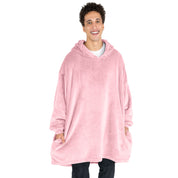 A man has a microplush wearable blanket on and his hands are in the side pockets
