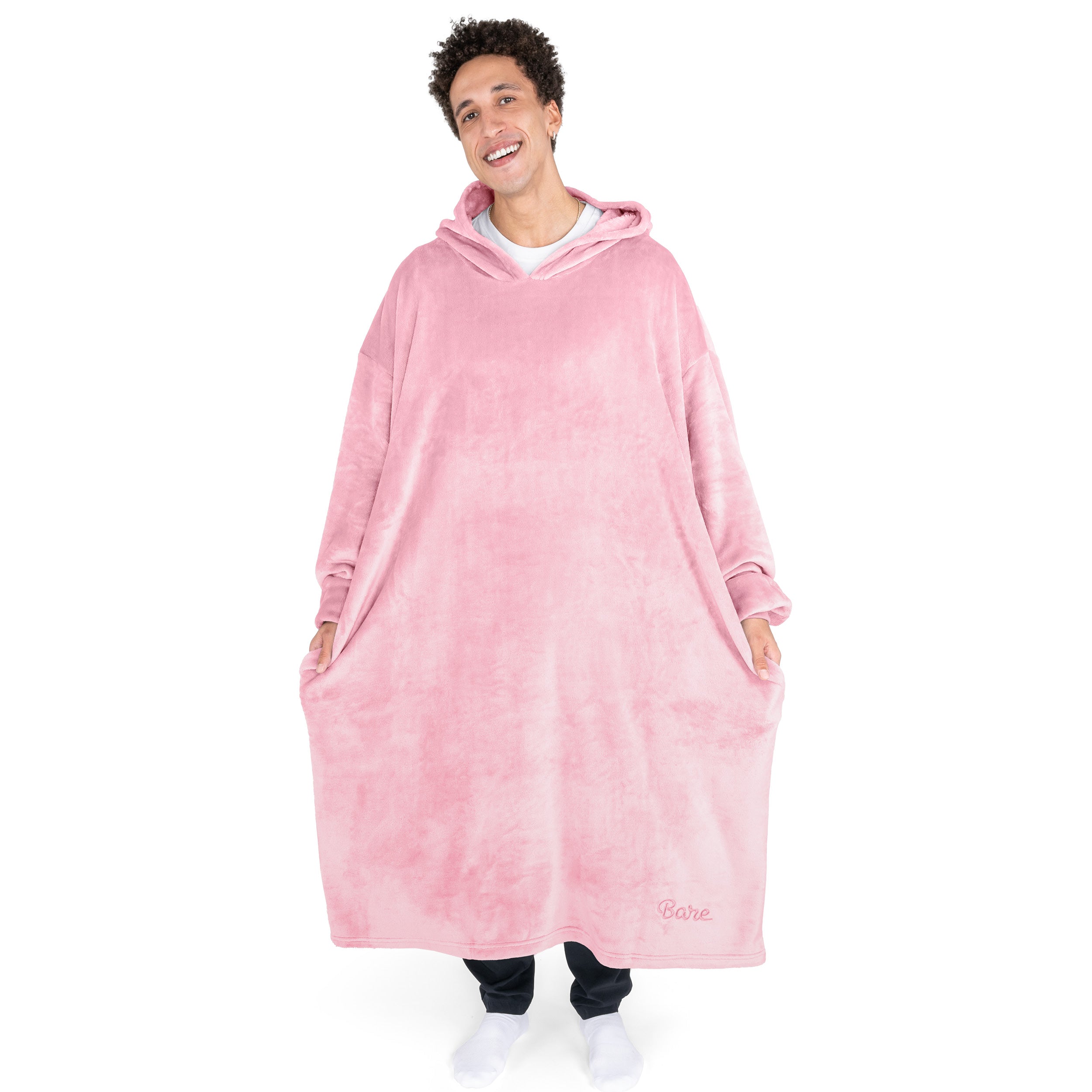 An adult with long microplush wearable blanket on