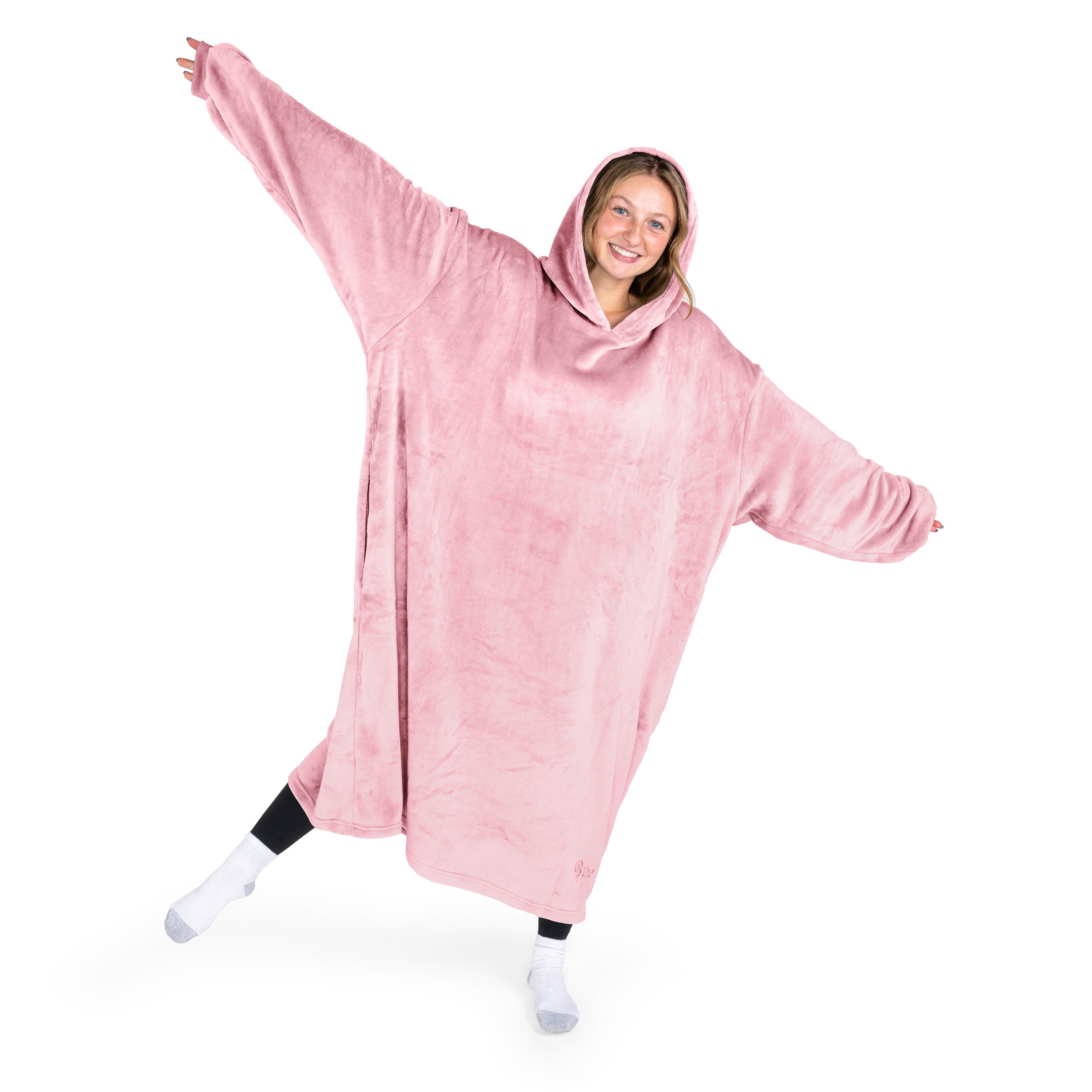 A woman has a hooded wearable blanket on