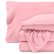 Fleece sheets folded neatly and stacked with pillows inside the pillowcases