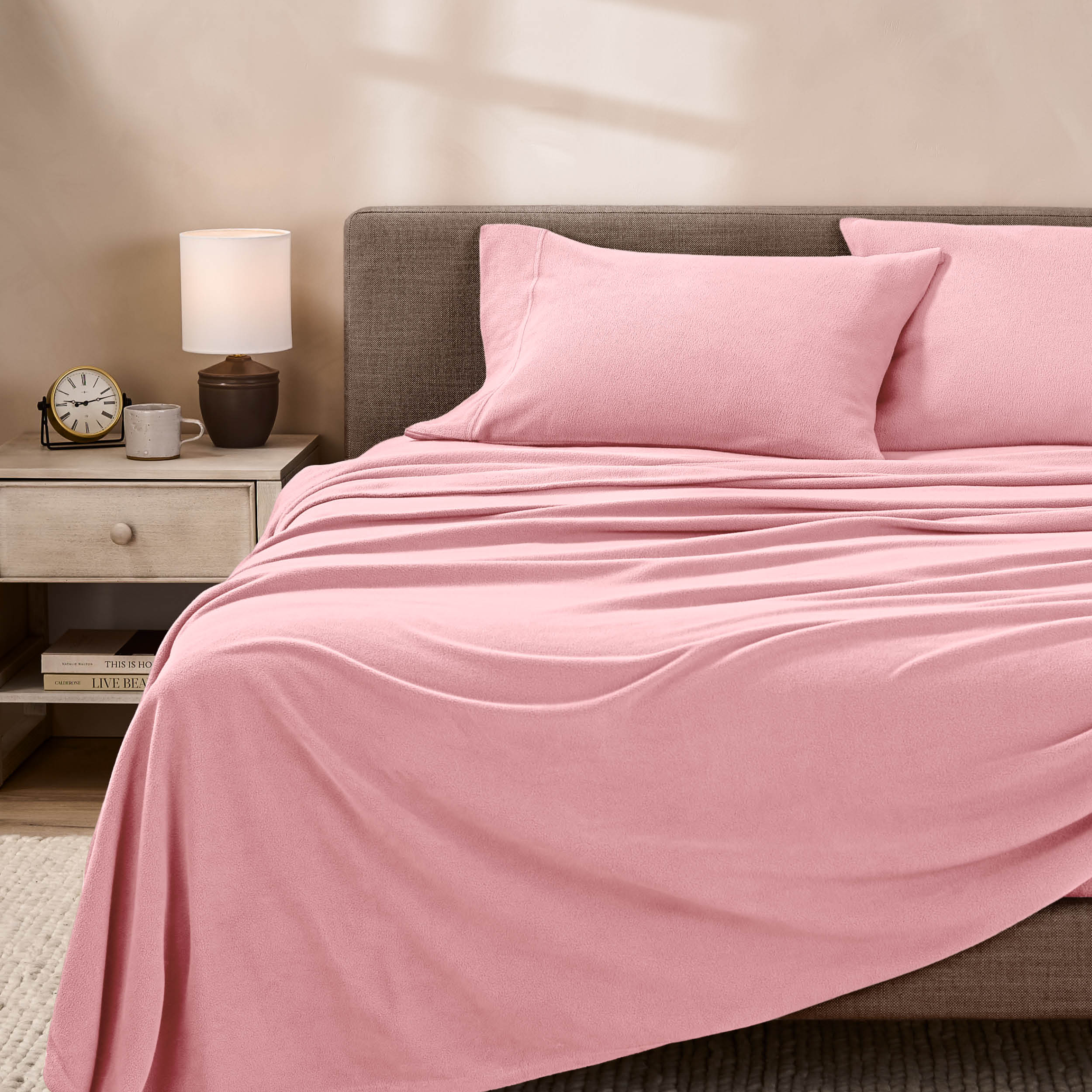 View of fleece sheets from the end of a bed with the top sheet draped over the side and end