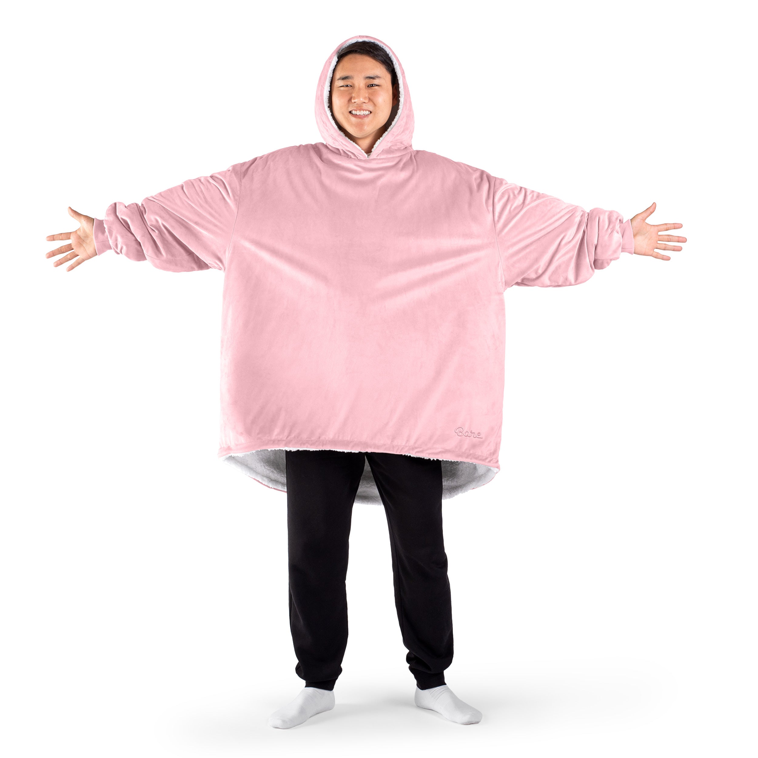 An adult with a sherpa wearable blanket on